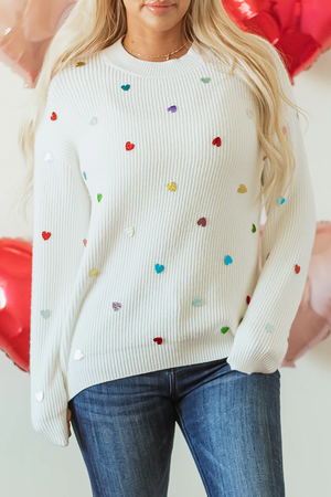 model in a boutique clothing sequin hearts sweater